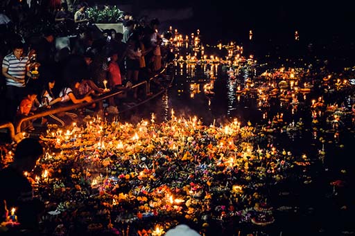 Loy Krathong Candle-lit krathong floating on the Ping River during Loy Krathong in Chiang Mai