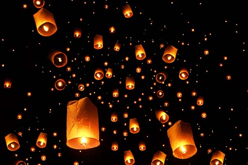 swarms of sky floating lanterns are launched into the air during Lantern release ceremony at Yee Peng Lanna International near Mae Jo, Chiang Mai