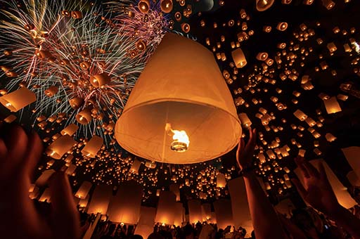 Thai people floating lamp Sky lanterns rising at a mass release event near Chiang Mai