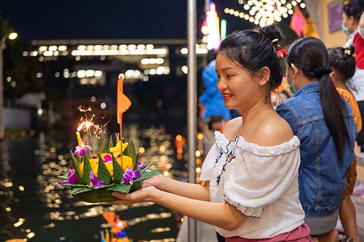 Visitors floating krathong on the Ping River during Loy Krathong in Chiang Mai